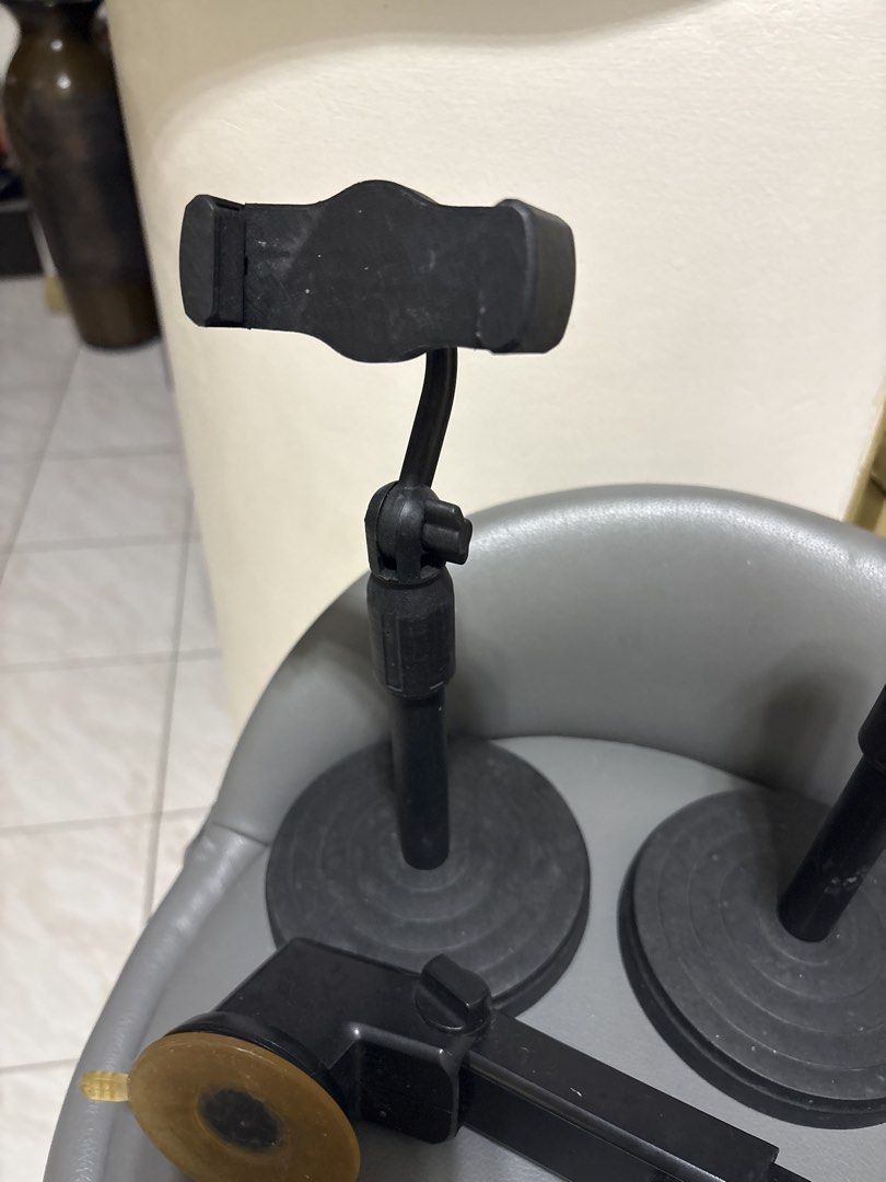 3x Phone Stands (Category: Mounts & Holders) located in Pasig City. Submitted by myprelovedcollectibles (Listing ID 1441646624, Image 2). Description: - Set of 3 black phone stands - Sturdy round bases - Adjustable arms for optimal positioning - Secure phone holders - Includes a separate suction cup mount attachment - Ideal for hands-free viewing and recording - Perfect for use on desks and tables.