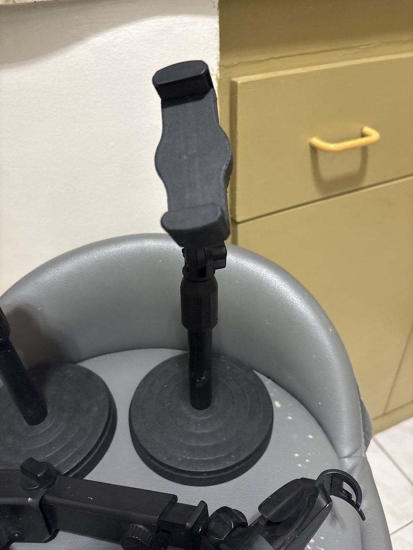 3x Phone Stands (Category: Mounts & Holders) located in Pasig City. Submitted by myprelovedcollectibles (Listing ID 1441646624, Image 3). Description: - Set of 3 black phone stands - Sturdy round bases - Adjustable arms for optimal positioning - Secure phone holders - Includes a separate suction cup mount attachment - Ideal for hands-free viewing and recording - Perfect for use on desks and tables.