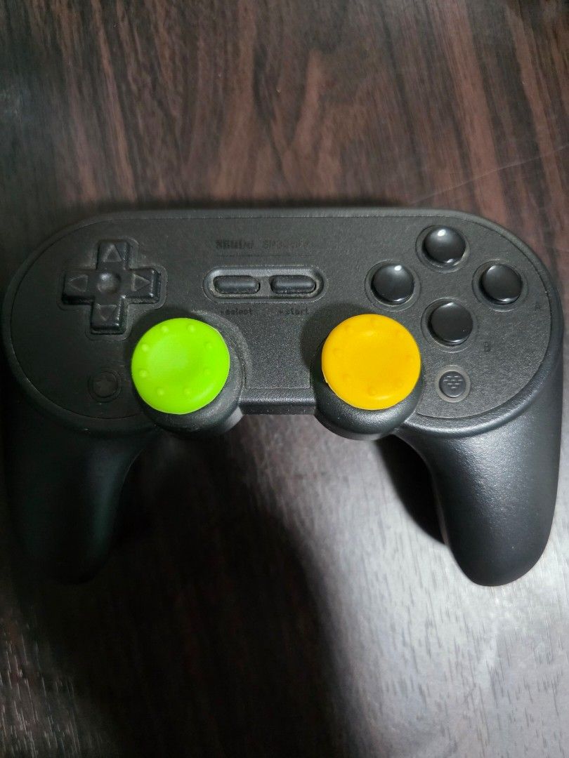 8bitdo Wireless Bluetooth Controller (Category: Controllers) located in Manila. Submitted by chaarliee (Listing ID 1441747400, Image 1). Description: - Black game controller - Yellow and green thumb grips on analog sticks - D-pad and face buttons visible - Battery compartment on the back - Works well.