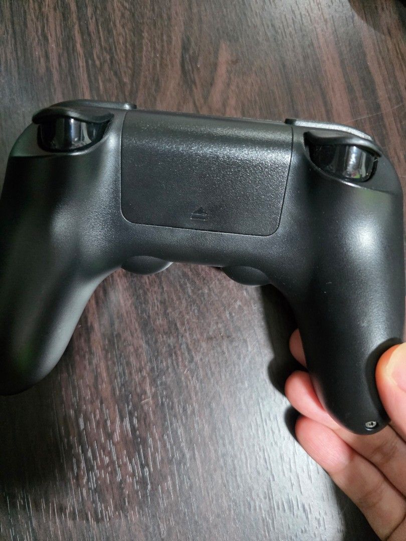 8bitdo Wireless Bluetooth Controller (Category: Controllers) located in Manila. Submitted by chaarliee (Listing ID 1441747400, Image 2). Description: - Black game controller - Yellow and green thumb grips on analog sticks - D-pad and face buttons visible - Battery compartment on the back - Works well.