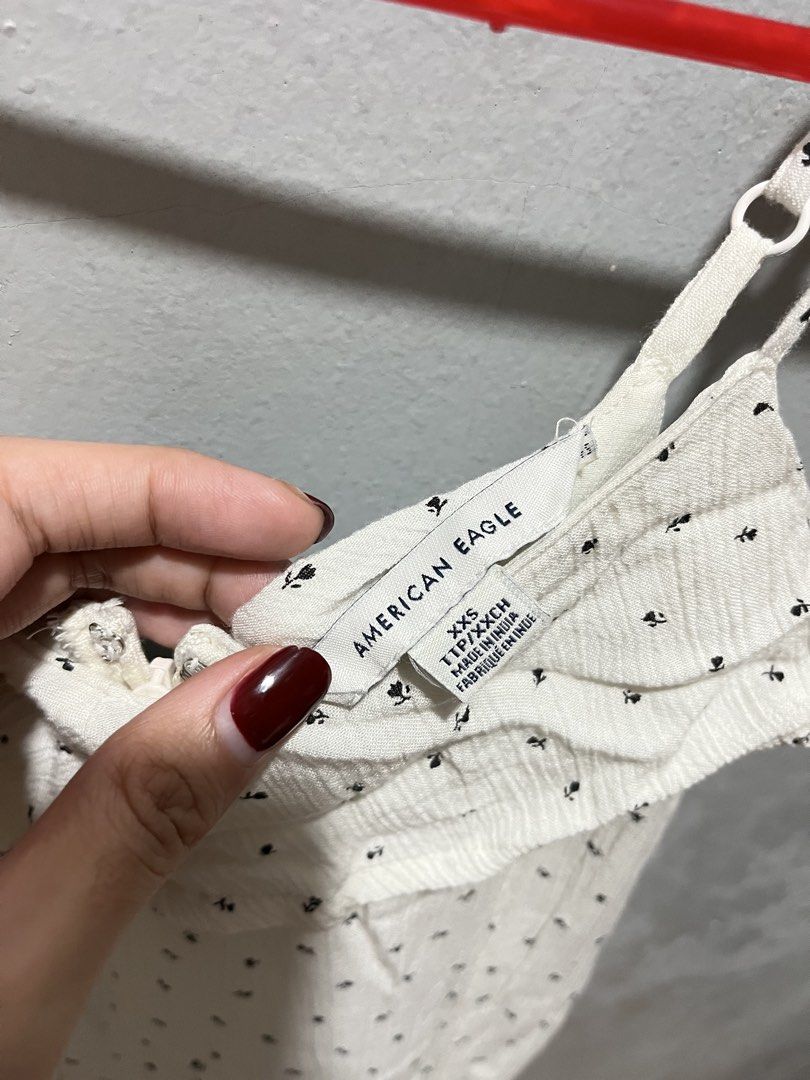 American Eagle White Mini Floral Dress (Category: Dresses) located in Taguig. Submitted by ls_ln (Listing ID 1441625599, Image 2). Description: - Cute white dress - Small black floral pattern - Ruffled neckline - Thin straps - Lightweight fabric, ideal for warm weather - Ideal for casual or beach wear - Size: XS-S - ww available (pm).