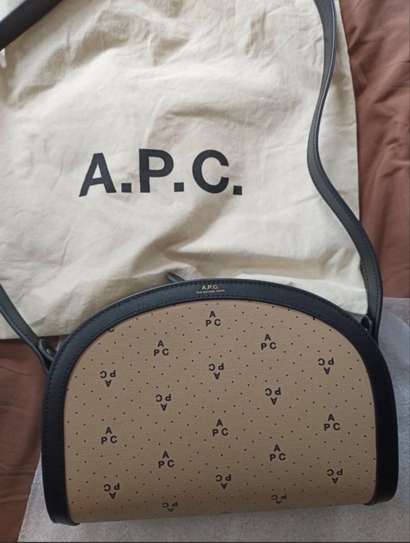 A.P.C. Demi-Lune Bag Monogram Canvas Leather (Category: Cross-body Bags) located in San Juan City. Submitted by j.a.acct2 (Listing ID 1441725632, Image 2). Description: - A.P.C. crossbody bag - Monogram pattern on canvas with leather trim - Adjustable shoulder strap - Zip closure - Comes with original dust bag - Ideal for everyday use.