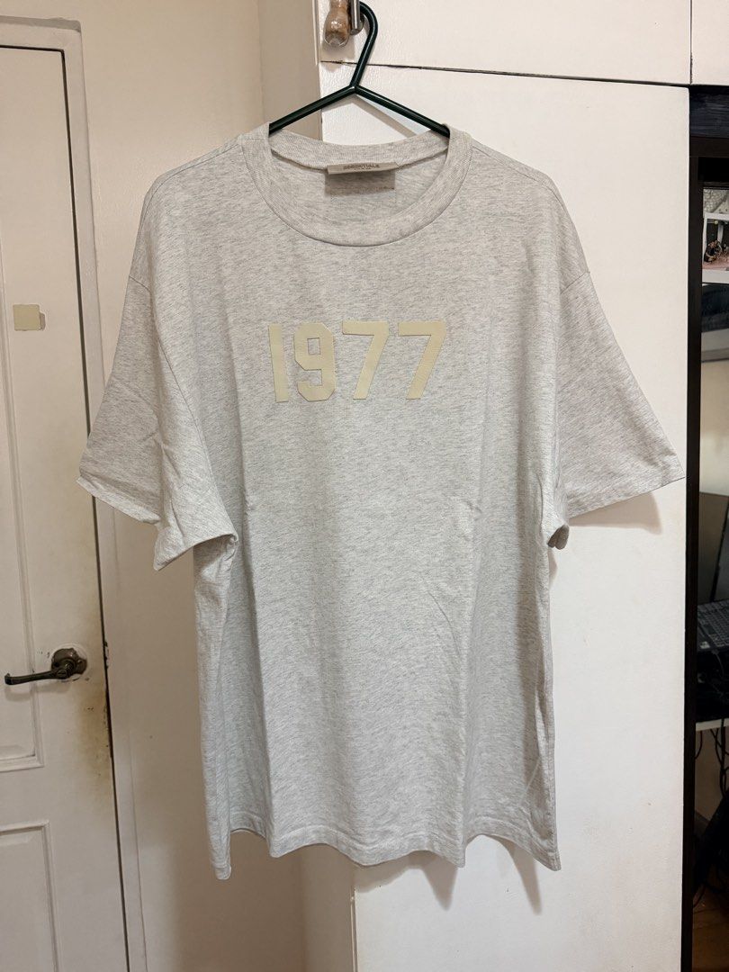 (Authentic) Essentials Fear of God 1977 Shirt Heather Grey (Category: Tshirts & Polo Shirts ) located in Cavite. Submitted by kumbin (Listing ID 1441611551, Image 2). Description: Essentials Fear of God 1977 Shirt (100% legit) Not thrifted, first owner Heather grey color, soft heavy fabric 🩶 Dimensions: 24 by 30 inches (XL fitting) Issue: Altered, kaya nawala na yung tags. (L on tag kasi ito and sobrang laki kaya pina alter ko ng size ko). Kaya 
