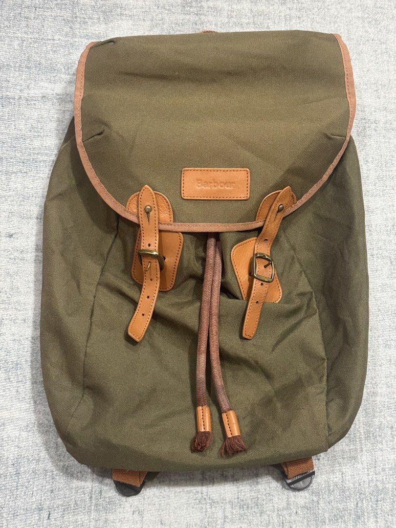 Barbour - Lifestyle Lachie Backpack (Category: Backpacks) located in Manila. Submitted by members-only (Listing ID 1441718720, Image 3). Description: Barbour Lifestyle Lachie Backpack, in olive.A versatile backpack is made from a lightweight yet durable outer fabric with real leather trim. The main compartment fastens with a chunky drawstring and is secured by a flap with leather straps featuring mock buckles and quick release studs.Adjustable sh