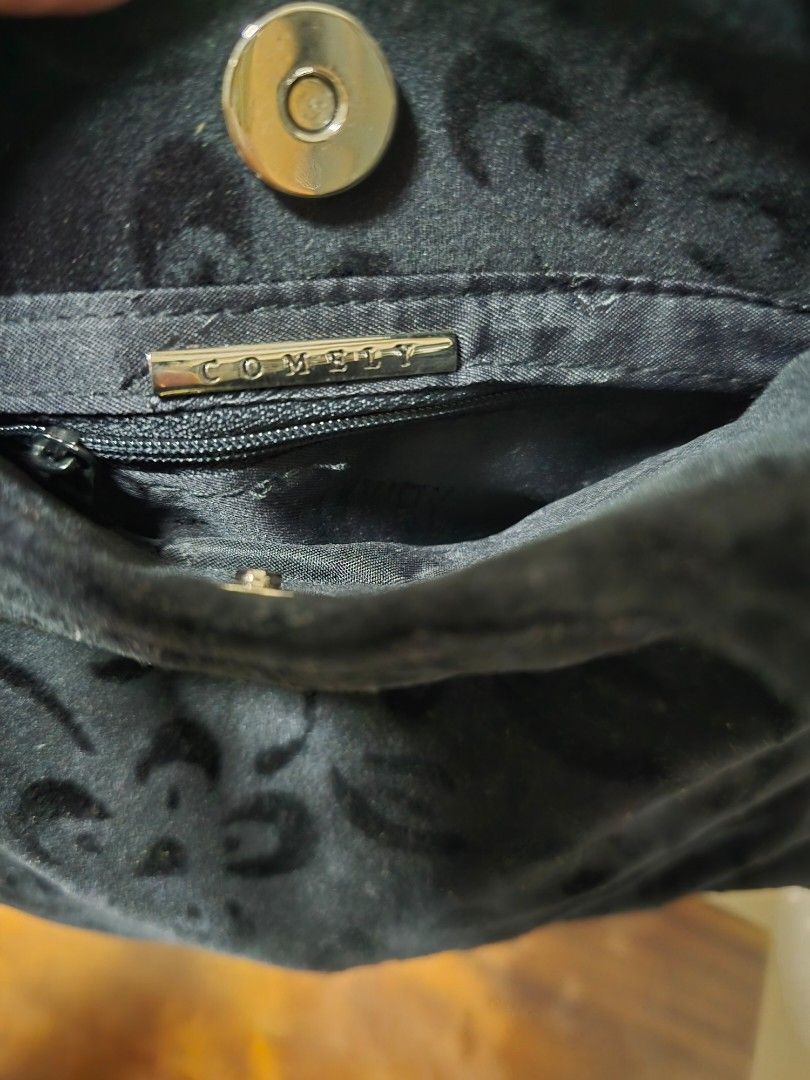 Black Velvet Handbag with Embossed Pattern (Category: Shoulder Bags) located in Singapore. Submitted by graciously16 (Listing ID 1441712978, Image 3). Description: - Black velvet handbag - Elegant embossed pattern all over - Single handle for comfortable carrying - Interior zippered pocket with metal pull tab - 'COMELY' brand detail on zipper pull - Secure magnetic front closure.
