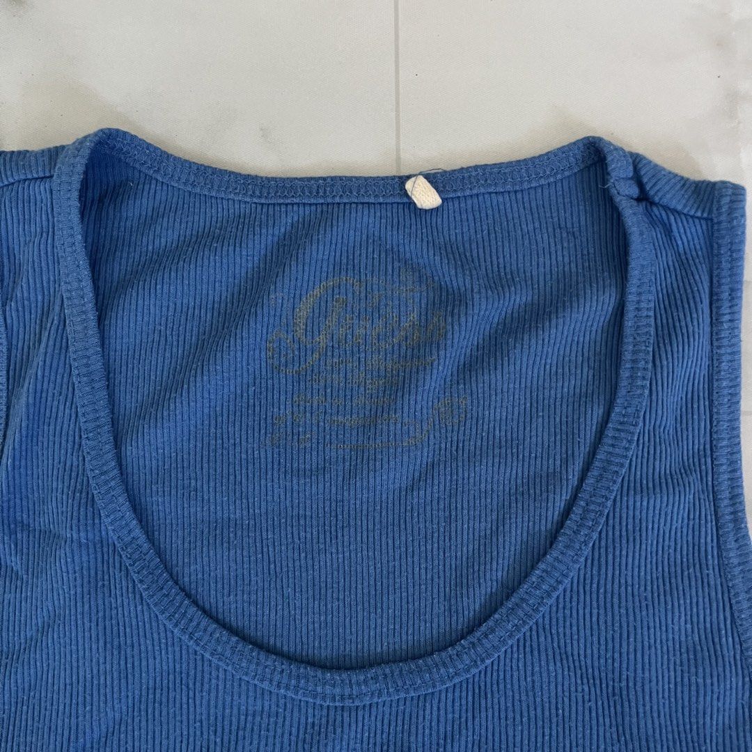 Blue Guess Tank Top with Rhinestone Logo (Category: Sleeveless) located in Manila. Submitted by giormagne (Listing ID 1441609486, Image 3). Description: - Blue ribbed Guess tank top - Features Guess logo with sparkling rhinestones - Sleeveless design - Ideal for casual wear - Pairs well with jeans or shorts.