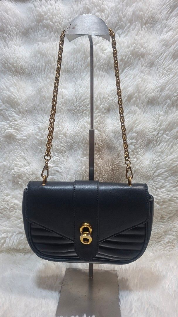 Charles & Keith Black Quilted Chain Shoulder Bag (Category: Shoulder Bags) located in Panabo. Submitted by Djars_Finds (Listing ID 1441750705, Image 1). Description: - Black quilted shoulder bag by Charles & Keith - Elegant gold chain strap - Secure buckle closure - Interior brand label - Approx. 8" W x 5" H - Versatile for nights out or daily wear - This are thrifted items so manage your expectation unless stated - What you see is what you get -