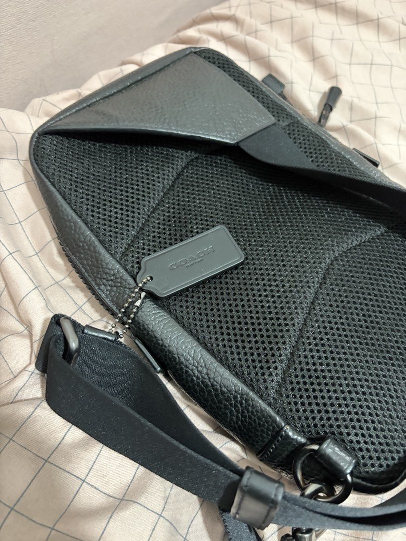 Coach Black Leather Sling Bag (Category: Luxury Bags & Wallets) located in Mandaluyong City. Submitted by getbounced (Listing ID 1441694368, Image 3). Description: - Authentic Coach black pebbled leather sling bag - Adjustable strap for comfortable wear - Spacious main compartment with secure zip closure - Padded mesh back for added comfort during use - Comes with original Coach leather tag - Ideal for everyday errands and activities.