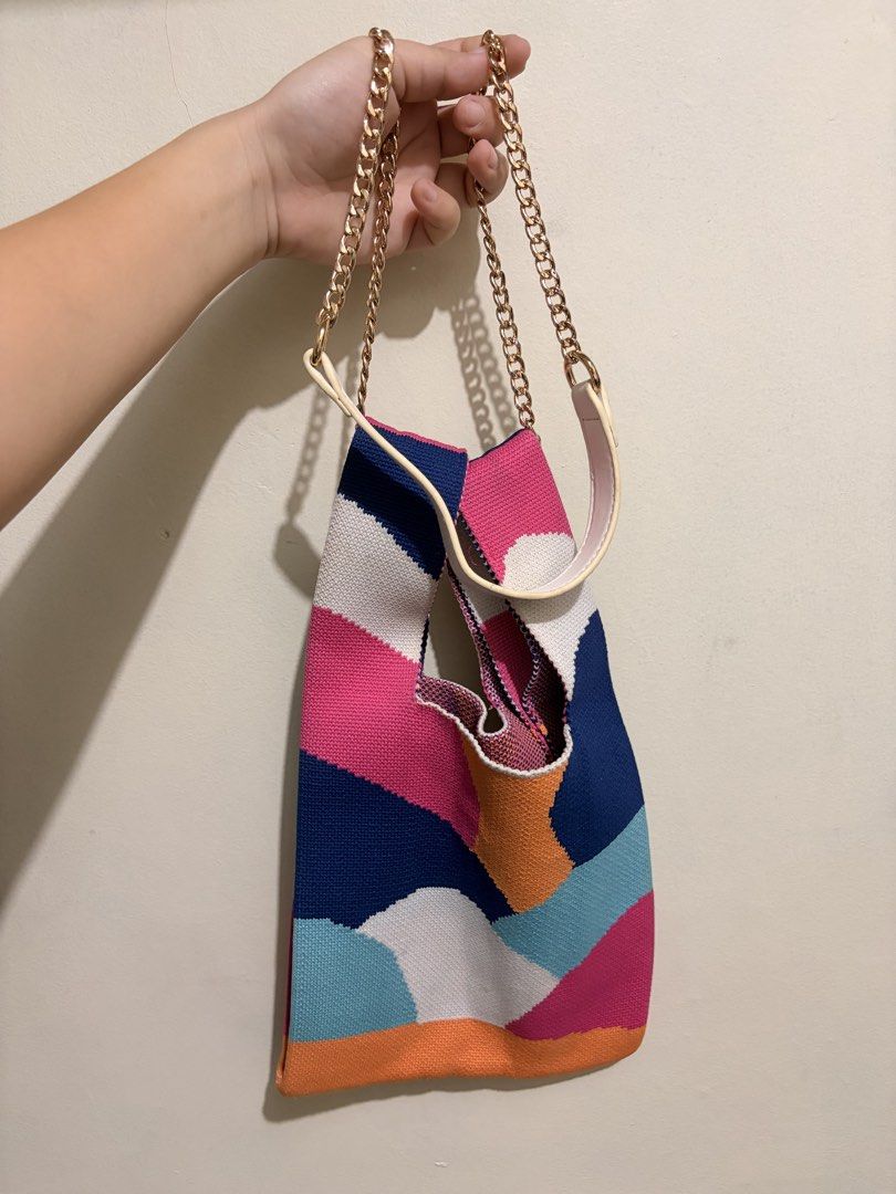 Colorful Geometric Knit Knot Bag (Category: Purses & Pouches) located in Mandaluyong City. Submitted by chynchilla (Listing ID 1441626214, Image 3). Description: - can be used/styled as knot or strapped cross body bag - chain strap included (a bit worn out on leather part) - no flaws on the bag itself.