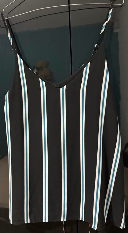 COTTON ON Black Striped Cami Top (Category: Sleeveless) located in Quezon City. Submitted by ndrmkl (Listing ID 1441616041, Image 2). Description: - Black cami top - White and teal stripes - V-neckline - Thin, adjustable straps - Lightweight material - Perfect for layering or wearing solo - Easy to pair with jeans or shorts.