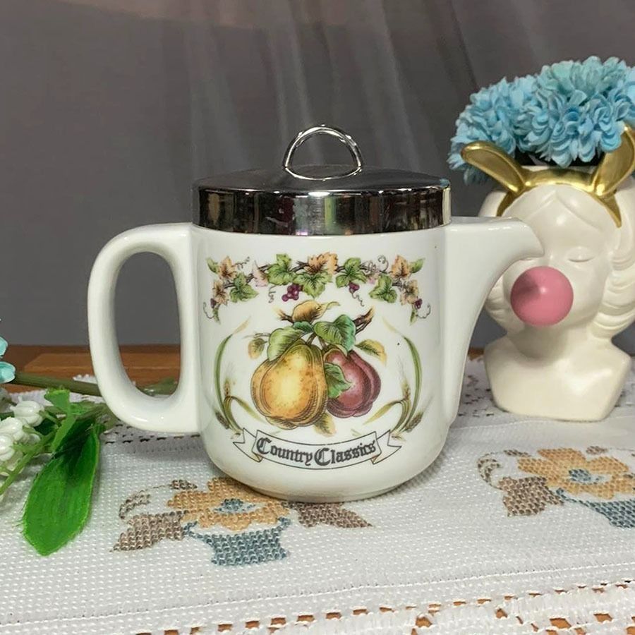 Country Classics Ceramic Teapot with Silver Lid (Category: Coffee & Tea Tableware) located in Mandaluyong City. Submitted by yula_noveltyfinds (Listing ID 1441588087, Image 1). Description: - Japan surplus - Cute teapot from Country Classics - Features a lovely pear and grape design - Shiny silver lid with a small handle - Metal Lid has scratches (Not for finicky buyers) - Ceramic body in good condition - Perfect for serving tea or as a decorativ