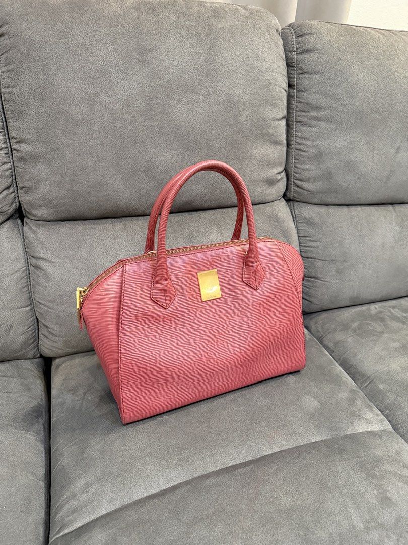 Couronne Red Hand Bag (Category: Luxury Bags & Wallets) located in Valenzuela. Submitted by laureenishappy (Listing ID 1441731564, Image 1). Description: - Classic alma style bag - red color Epi leather - Structured shape with top handles - Gold hardware detail on the front - Secure zipper closure - Spacious interior for daily essentials - A timeless and versatile piece.