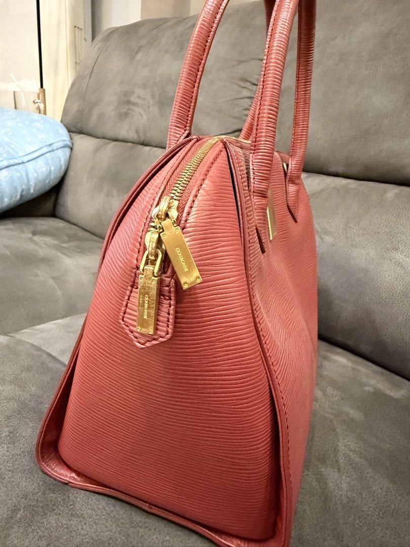 Couronne Red Hand Bag (Category: Luxury Bags & Wallets) located in Valenzuela. Submitted by laureenishappy (Listing ID 1441731564, Image 2). Description: - Classic alma style bag - red color Epi leather - Structured shape with top handles - Gold hardware detail on the front - Secure zipper closure - Spacious interior for daily essentials - A timeless and versatile piece.