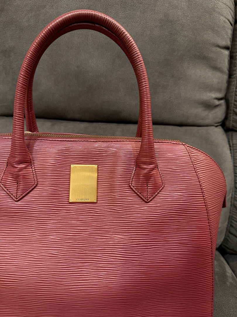 Couronne Red Hand Bag (Category: Luxury Bags & Wallets) located in Valenzuela. Submitted by laureenishappy (Listing ID 1441731564, Image 3). Description: - Classic alma style bag - red color Epi leather - Structured shape with top handles - Gold hardware detail on the front - Secure zipper closure - Spacious interior for daily essentials - A timeless and versatile piece.