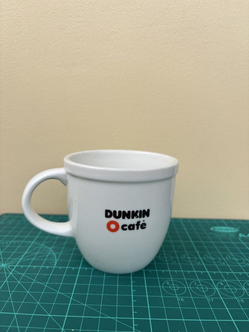 Dunkin' Cafe White Ceramic Coffee Mug (Category: Coffee & Tea Tableware) located in Antipolo. Submitted by anabri (Listing ID 1441678940, Image 2). Description: - White ceramic mug from Dunkin' Cafe - Features the iconic Dunkin' logo - Sturdy handle for a comfortable grip - See photos for details.