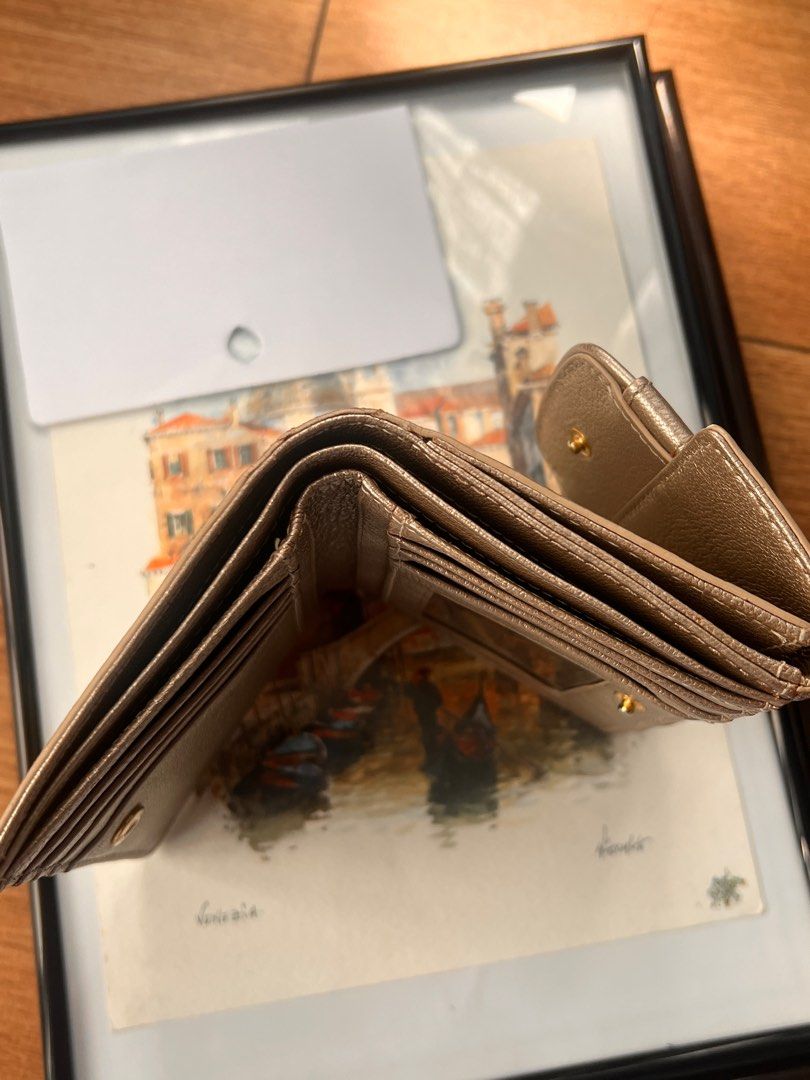 Givenchy Metallic Leather Billfold Wallet (Category: Luxury Bags & Wallets) located in Pasig City. Submitted by curatedbywill (Listing ID 1441645705, Image 3). Description: - Authentic Givenchy wallet (circa 2008-2010) - Metallic bronze leather - Bi-fold design with snap closure - Multiple interior card slots - Clear ID window - Comes with original box and wrapping paper - Ideal for everyday use - BOUGHT THE ITEM FROM RAGTAG IN OMOTESANDO, TOKYO 
