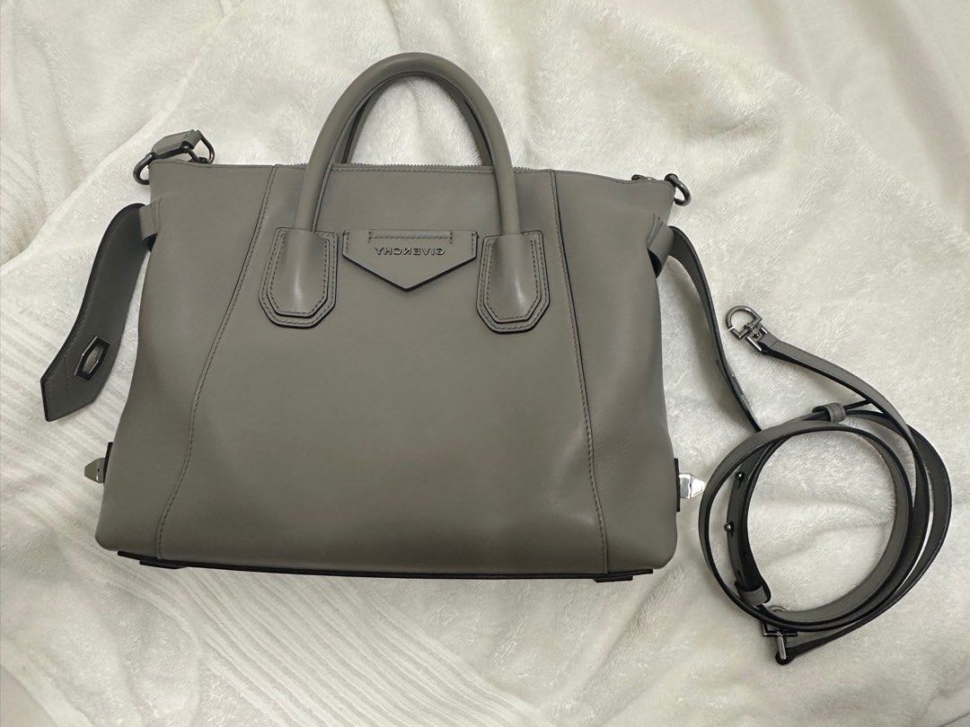 Givenchy Pearl Grey Smooth Leather Small Antigona Soft Bag (Category: Luxury Bags & Wallets) located in Paranaque City. Submitted by innersmile (Listing ID 1441742913, Image 2). Description: - Authentic Grey Leather Givenchy Antigona - Includes Original Dust Bag, Shopping Bag, Cards and Receipt - Features Top Handles and Detachable Shoulder Strap - Silver-Toned Hardware - Bought in SG for 2990 SGD yr 2022 Rfs- decluttering - Steal deal!.