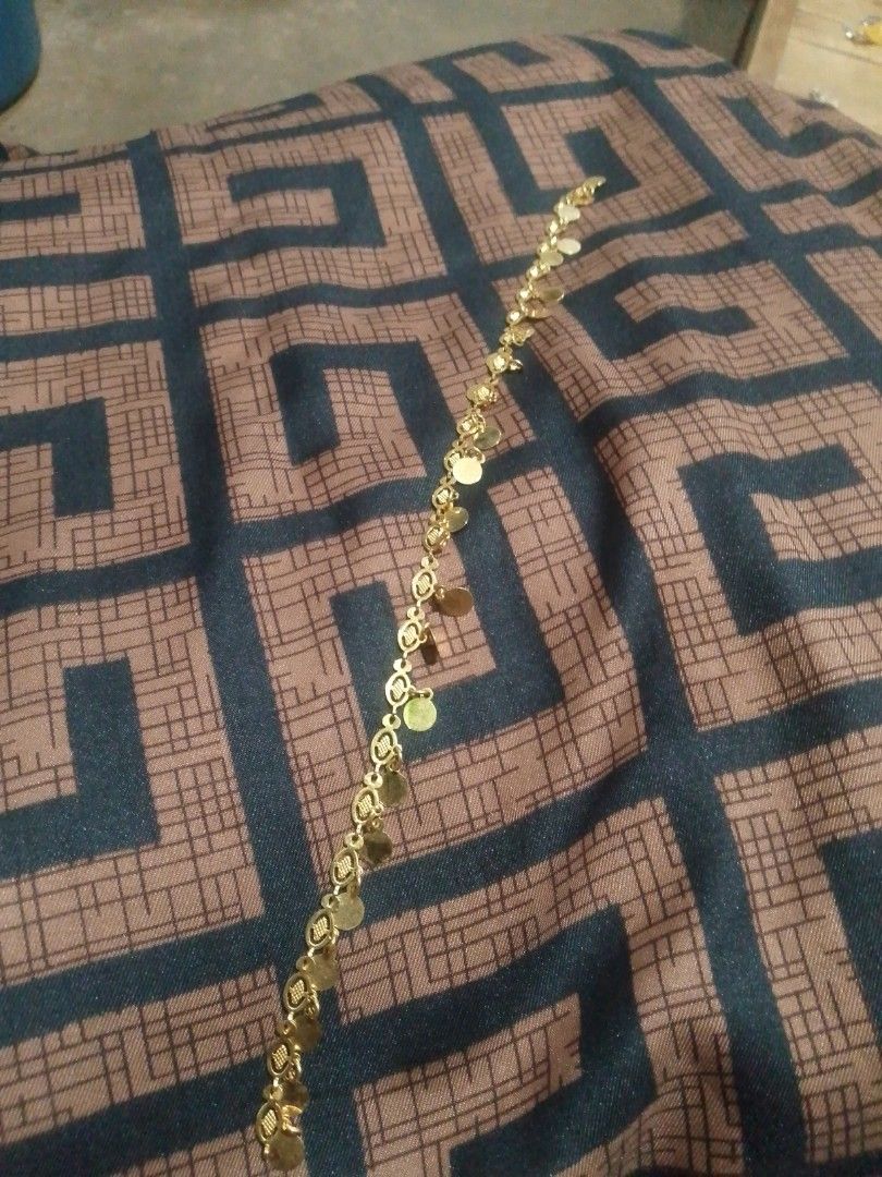 Gold Bracelet with Coin Charms (Category: Bracelets) located in Manila. Submitted by epicwind_1bf746 (Listing ID 1441756434, Image 2). Description: - Gold-toned bracelet - Features delicate coin-shaped charms - Delicate chain design - Approximately 7 inches long - Secure clasp closure - Perfect for adding a touch of sparkle.