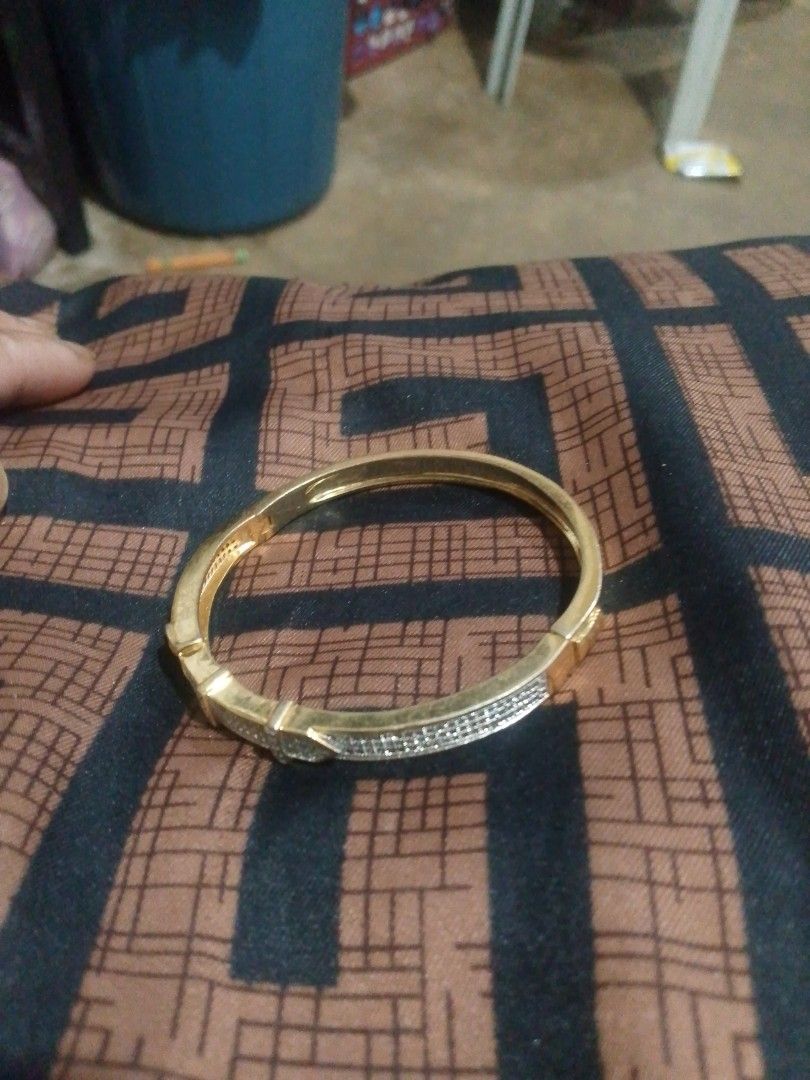 Gold Tone Bangle Bracelet with Rhinestones (Category: Bracelets) located in Manila. Submitted by epicwind_1bf746 (Listing ID 1441757243, Image 2). Description: - Gold tone bangle bracelet - Unique belt buckle design - Adorned with clear stones all around - Perfect for dressing up your look - Approx. 2.5 inches in diameter - Secure and reliable clasp - Shiny and eye-catching piece.