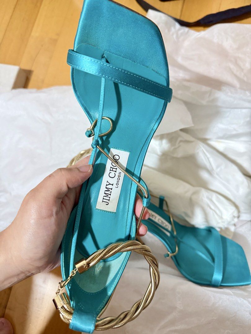 Jimmy Choo Oriana heels (Category: Heels) located in Makati City. Submitted by closetbank (Listing ID 1441777326, Image 2). Description: Jimmy Choo Oriana Heels Color: Blue/Turquoise Material: Satin Style: Square toe heels with delicate ankle straps Detail: Gold twisted rope accent around the ankle Heel height: 110mm/4.3 inches Size: 36 Origin: Made in Italy Condition: Soles show some signs of wear Inclusions: heels and box Rfs: decluttering.