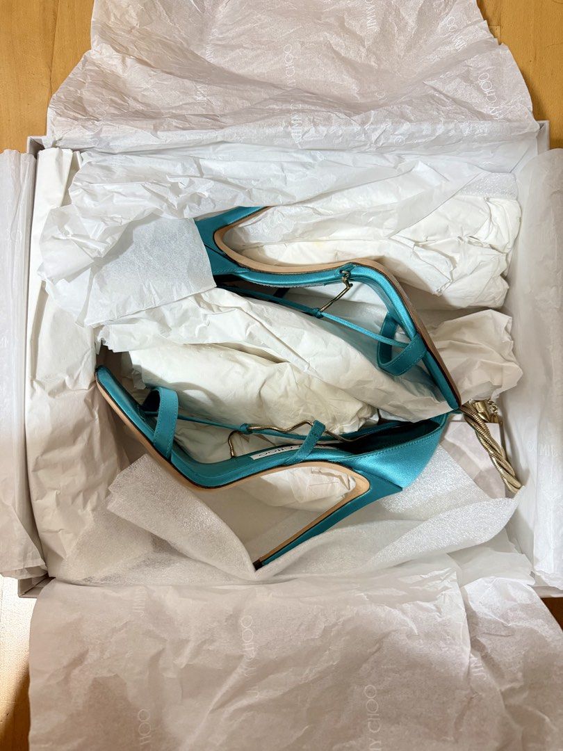 Jimmy Choo Oriana heels (Category: Heels) located in Makati City. Submitted by closetbank (Listing ID 1441777326, Image 1). Description: Jimmy Choo Oriana Heels Color: Blue/Turquoise Material: Satin Style: Square toe heels with delicate ankle straps Detail: Gold twisted rope accent around the ankle Heel height: 110mm/4.3 inches Size: 36 Origin: Made in Italy Condition: Soles show some signs of wear Inclusions: heels and box Rfs: decluttering.