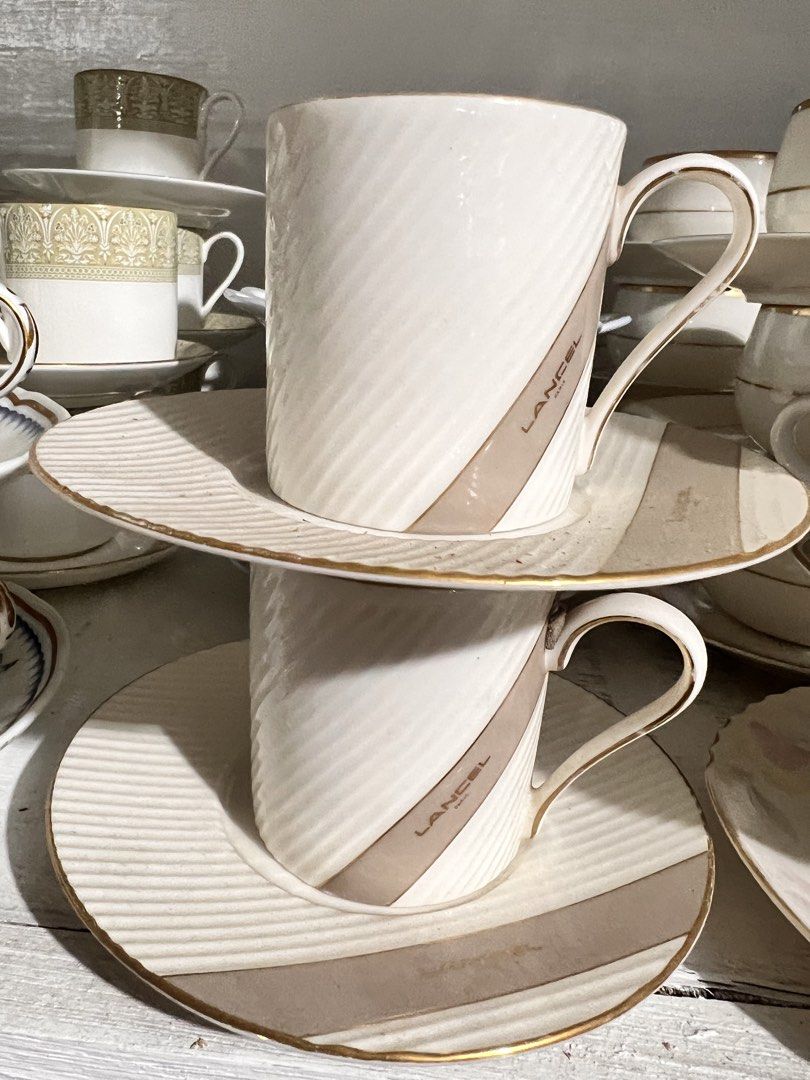 Lancel Paris Cup and Saucer Set (Category: Coffee & Tea Tableware) located in Manila. Submitted by suarezbaby04975 (Listing ID 1441722427, Image 1). Description: - Set of 2 Lancel Paris cups and saucers - Elegant cream color with a subtle diagonal ribbed texture - Features a chic taupe stripe with the iconic Lancel Paris logo - Finished with a sophisticated gold trim on the edges - Ideal for enjoying your favorite coffee or tea in style.