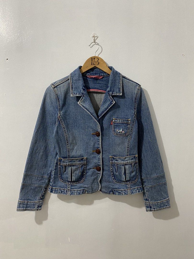 Levi's Denim Blazer Jacket with Bird Embroidery (Category: Coats, Jackets and Outerwear) located in Pasay City. Submitted by ralphorhtej (Listing ID 1441740322, Image 1). Description: - Cute Levi's denim blazer - Light wash blue color - Two front pockets with button closures - Small embroidered bird detail on chest pocket - Button front closure - Versatile for layering over tees or dresses - Classic wardrobe staple.