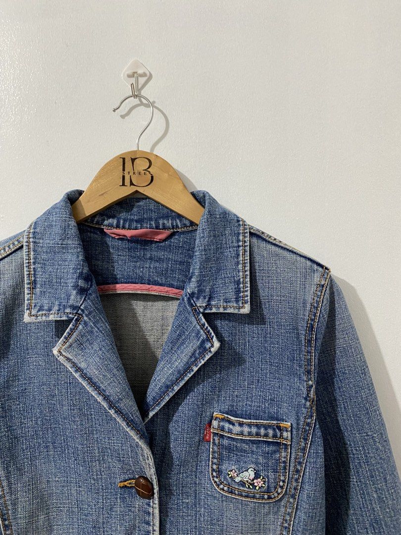 Levi's Denim Blazer Jacket with Bird Embroidery (Category: Coats, Jackets and Outerwear) located in Pasay City. Submitted by ralphorhtej (Listing ID 1441740322, Image 2). Description: - Cute Levi's denim blazer - Light wash blue color - Two front pockets with button closures - Small embroidered bird detail on chest pocket - Button front closure - Versatile for layering over tees or dresses - Classic wardrobe staple.