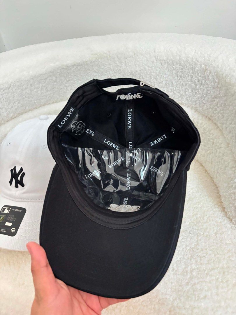 Loewe and MLB New York Yankees Caps (Category: Activewear) located in Makati City. Submitted by nixxx000 (Listing ID 1441599241, Image 1). Description: - Black Loewe baseball cap with adjustable strap - White New York Yankees MLB baseball cap with adjustable strap - Perfect for casual everyday wear - Both caps are adjustable for a comfortable fit.