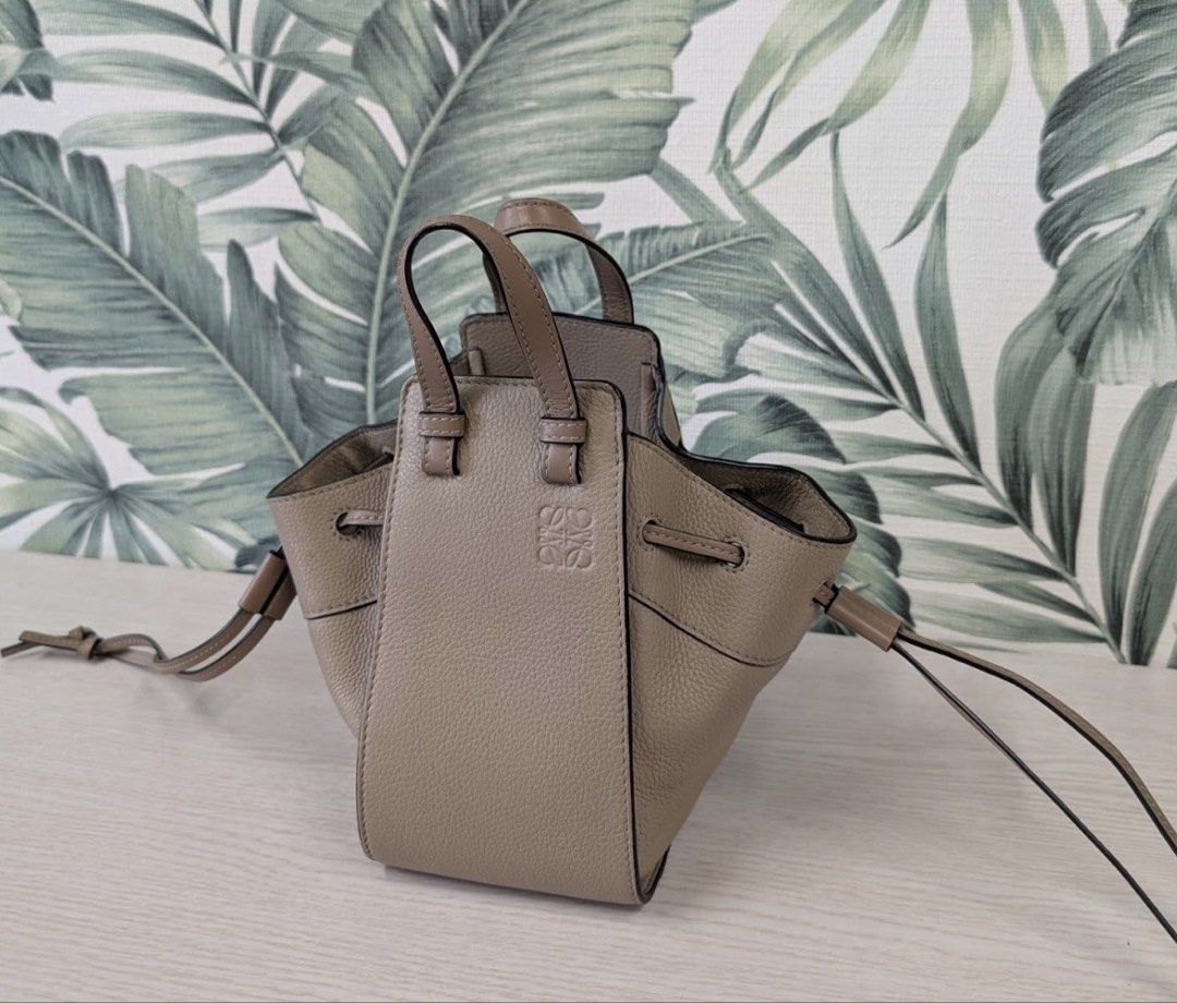 Loewe "Hammock" Bag Taupe Leather Drawstring Mini (Category: Luxury Bags & Wallets) located in Quezon City. Submitted by gvice (Listing ID 1441638059, Image 2). Description: - Authentic Loewe Hammock Bag - Mini Size - Color: Taupe - Material: Textured Leather - Closure: Drawstring - Handles: Dual Top Handles - Strap: Detachable Shoulder Strap - Includes: Dust Bag, Authenticity Cards - Ideal for: Everyday Use.