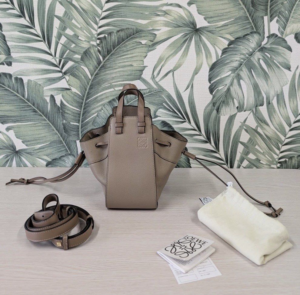 Loewe "Hammock" Bag Taupe Leather Drawstring Mini (Category: Luxury Bags & Wallets) located in Quezon City. Submitted by gvice (Listing ID 1441638059, Image 1). Description: - Authentic Loewe Hammock Bag - Mini Size - Color: Taupe - Material: Textured Leather - Closure: Drawstring - Handles: Dual Top Handles - Strap: Detachable Shoulder Strap - Includes: Dust Bag, Authenticity Cards - Ideal for: Everyday Use.