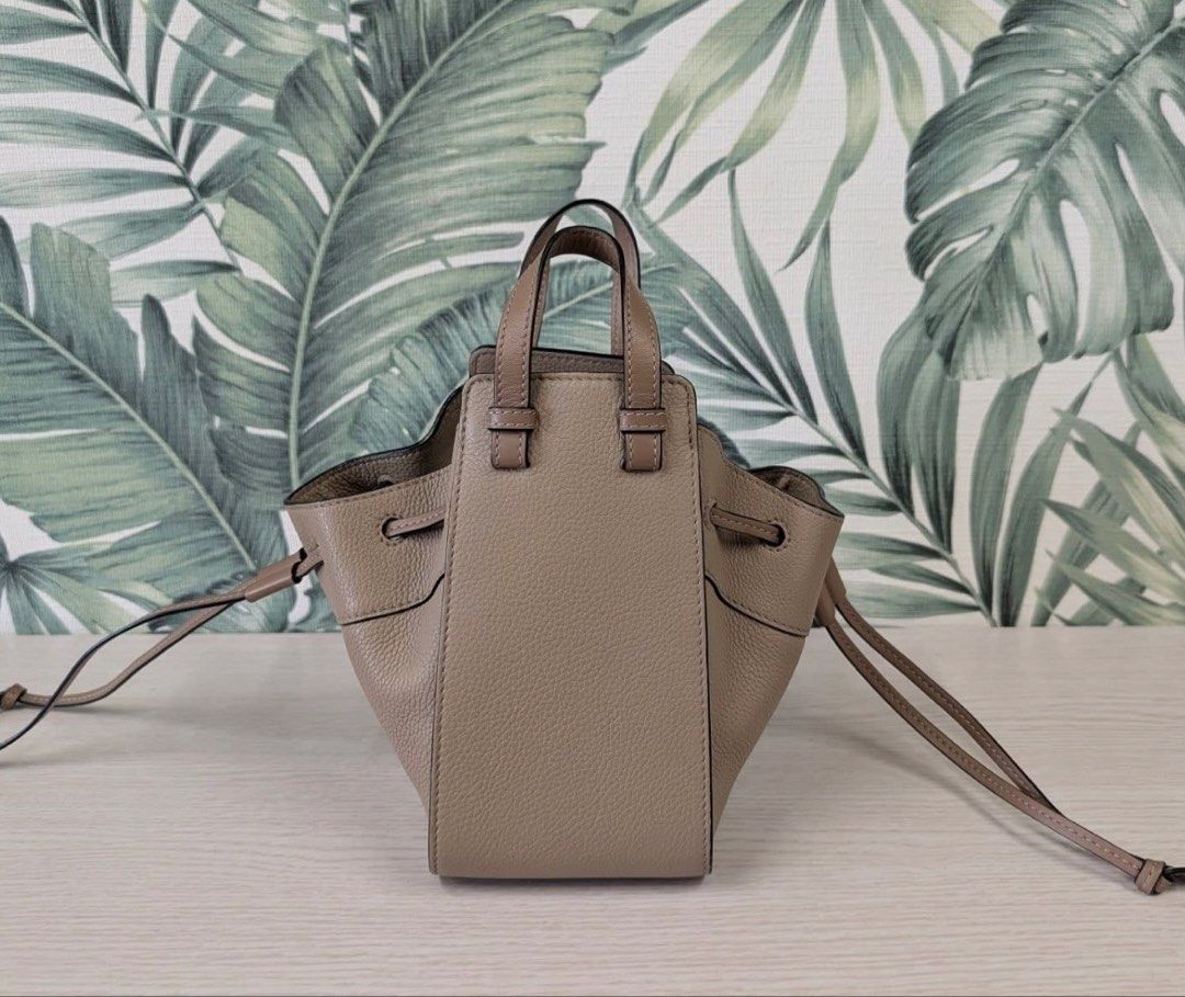 Loewe "Hammock" Bag Taupe Leather Drawstring Mini (Category: Luxury Bags & Wallets) located in Quezon City. Submitted by gvice (Listing ID 1441638059, Image 3). Description: - Authentic Loewe Hammock Bag - Mini Size - Color: Taupe - Material: Textured Leather - Closure: Drawstring - Handles: Dual Top Handles - Strap: Detachable Shoulder Strap - Includes: Dust Bag, Authenticity Cards - Ideal for: Everyday Use.
