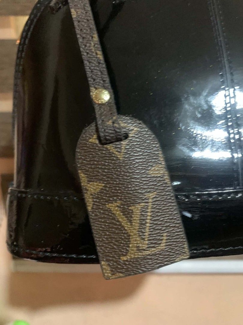 Louis Vuitton Monogram Vernis Alma BB Black (Category: Luxury Bags & Wallets) located in Aliaga. Submitted by akishaoshop2010. (Listing ID 1441711562, Image 3). Description: - Classic Louis Vuitton Alma BB bag - Black patent leather with signature monogram - Gold hardware and zipper - Includes a leather tag - Handles show some wear - Ideal for everyday use.