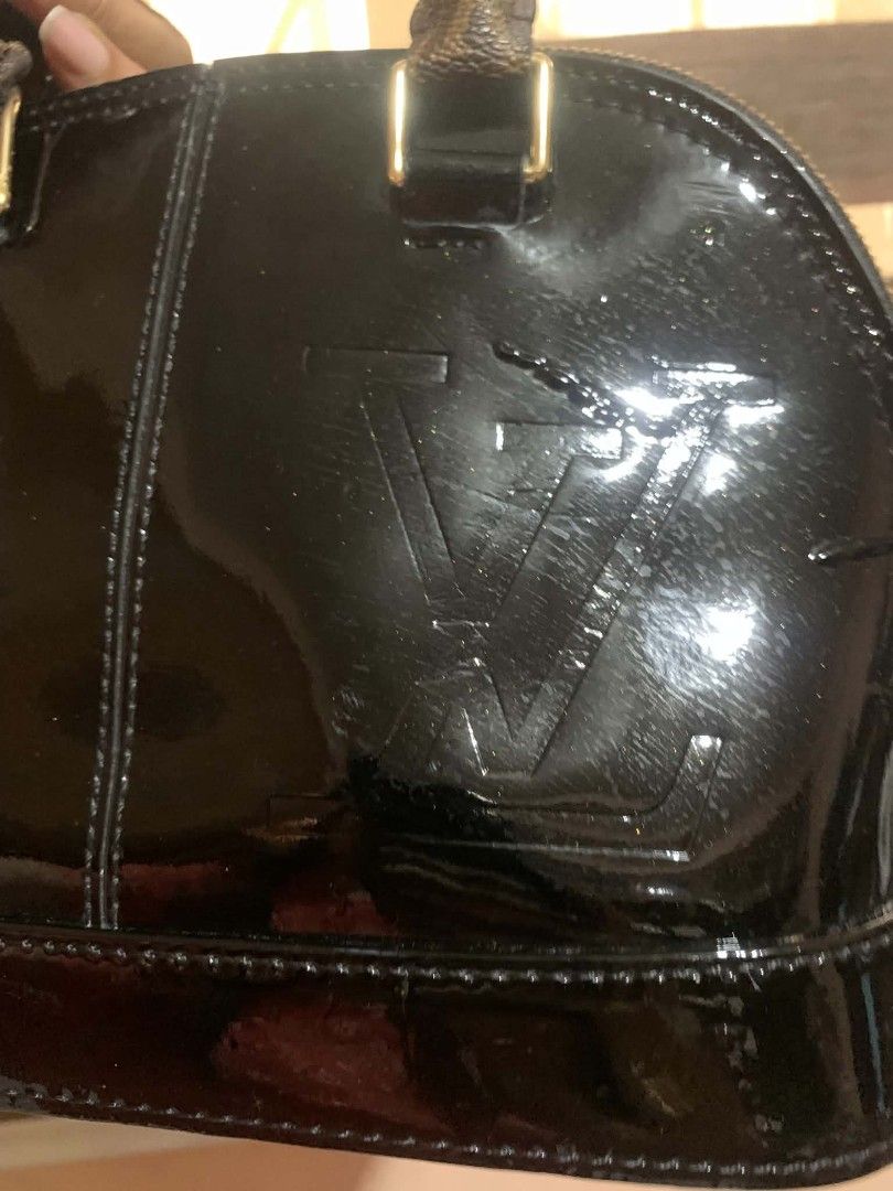 Louis Vuitton Monogram Vernis Alma BB Black (Category: Luxury Bags & Wallets) located in Aliaga. Submitted by akishaoshop2010. (Listing ID 1441711562, Image 2). Description: - Classic Louis Vuitton Alma BB bag - Black patent leather with signature monogram - Gold hardware and zipper - Includes a leather tag - Handles show some wear - Ideal for everyday use.