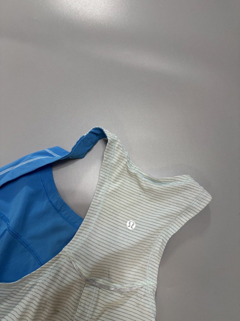 Lululemon Blue Striped Racerback Tank Top (Category: Activewear) located in Alaminos. Submitted by outfitcheck.ph (Listing ID 1441711385, Image 3). Description: - Blue Lululemon tank top - Light blue and white stripe details on back and sides - Racerback style - Small chest pocket on front - Ideal for workouts or casual wear - Comfortable and breathable material.