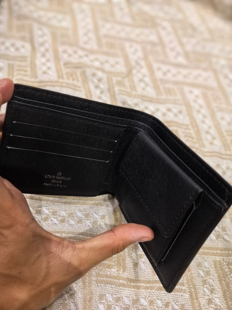 LV Black mono Leather Bifold Wallet (Category: Luxury Bags & Wallets) located in Cebu City. Submitted by esrpreloved (Listing ID 1441749296, Image 3). Description: - Material: Black mono Leather - Style: Bifold with Coin Pocket - Features: Ample card slots and compartments - Origin: Made in France - Condition: Good, with some signs of use.