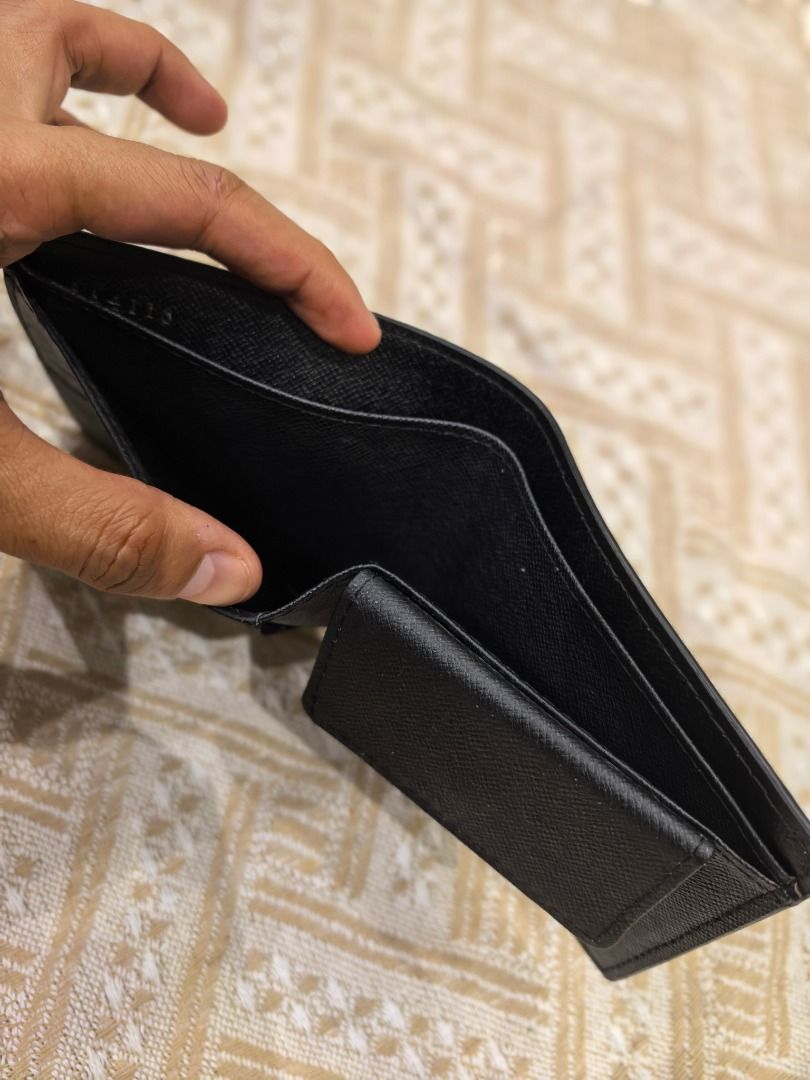 LV Black mono Leather Bifold Wallet (Category: Luxury Bags & Wallets) located in Cebu City. Submitted by esrpreloved (Listing ID 1441749296, Image 2). Description: - Material: Black mono Leather - Style: Bifold with Coin Pocket - Features: Ample card slots and compartments - Origin: Made in France - Condition: Good, with some signs of use.