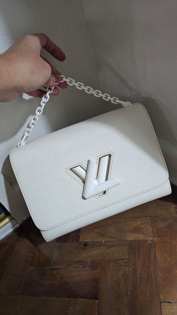 LV Epi Twist with detachable sling strap (Category: Shoulder Bags) located in Makati City. Submitted by mrsdm (Listing ID 1441664280, Image 1). Description: LV Epi Twist - Color: White - Signature LV twist lock closure - Detachable chain strap included - Ideal for evening use or as a clutch - Interior is clean - Minimal signs of wear.