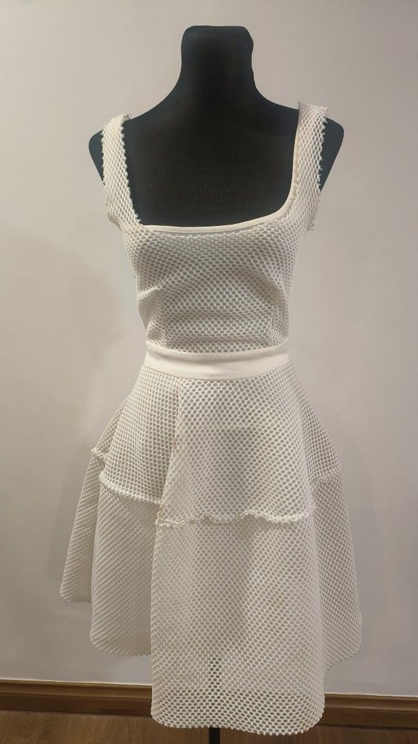 Maje Diva Honeycomb White Mesh Dress (Category: Dresses) located in Makati City. Submitted by fashion_thrift_ (Listing ID 1441623656, Image 3). Description: White mesh dress with a square neckline. Sleeveless design. The skirt has a ruffled, tiered look. Button details are visible on the skirt. Unique textured fabric. Great for a party or a casual outing..