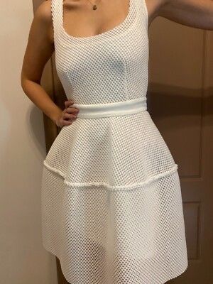 Maje Diva Honeycomb White Mesh Dress (Category: Dresses) located in Makati City. Submitted by fashion_thrift_ (Listing ID 1441623656, Image 2). Description: White mesh dress with a square neckline. Sleeveless design. The skirt has a ruffled, tiered look. Button details are visible on the skirt. Unique textured fabric. Great for a party or a casual outing..
