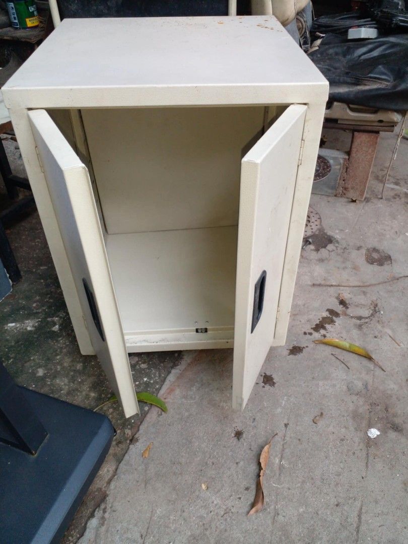 Metal Storage Cabinet with Double Doors (Category: Shelves, Cabinets & Racks) located in Manila. Submitted by wisegem-231b (Listing ID 1441613799, Image 1). Description: - Sturdy small metal cabinet - Features two doors with handles - Interior is empty, ideal for storing small items - Exterior has some dust and marks - Built to last, ready for a new home.