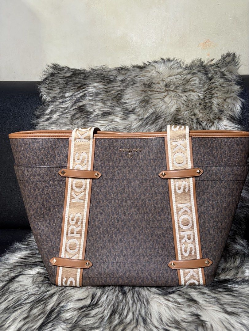 Michael Michael Kors Maeve monogram-print tote bag (Category: Tote Bags) located in Muntinlupa City. Submitted by charizze21 (Listing ID 1438648482, Image 2). Description: AUTHENTIC MK PRELOVED FROM US A chocolate brown monogram pattern logo plaque two rounded top handles concealed magnetic fastening internal zip-fastening pocket Product measurements Depth: 16 cm (6.29 in) Handle: 24 cm (9.44 in) Width: 43 cm (16.92 in) Height: 30 cm (11.81 in).