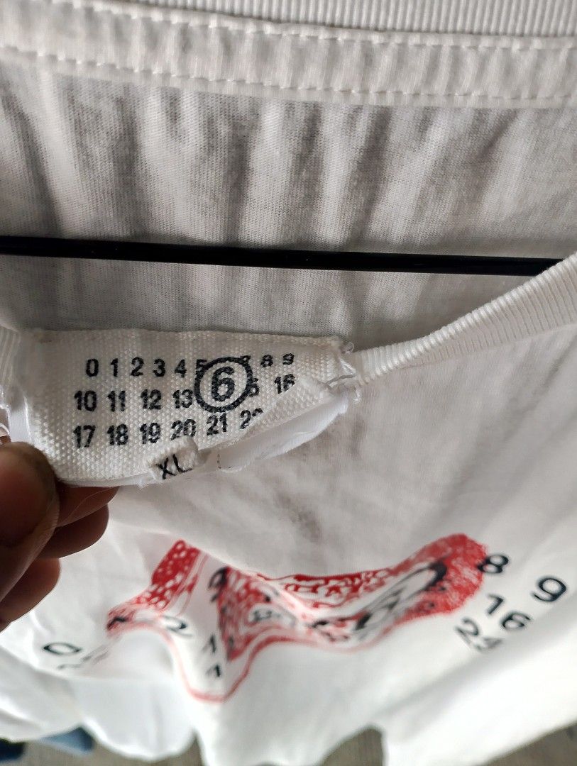 MM6 Maison Margiela White T-shirt Size XL (Category: Tshirts & Polo Shirts ) located in Manila. Submitted by jemarlubin04524 (Listing ID 1441611462, Image 2). Description: - Brand: MM6 Maison Margiela - Color: White - Size: XL - Design: Iconic numeric logo with snake graphic - Origin: Made in Italy - Perfect for fashion enthusiasts!.