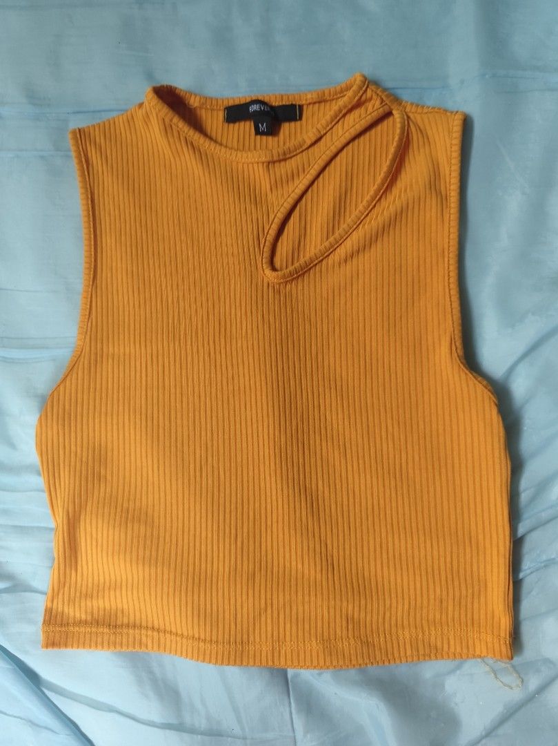 Mustard Yellow Ribbed Cut-Out Crop Top (Category: Sleeveless) located in Cavite. Submitted by emi_26 (Listing ID 1441659862, Image 1). Description: - Trendy yellow ribbed crop top - Sleeveless with a chic neckline cut-out - Stretchy and comfortable fabric - Perfect for pairing with high-waisted bottoms - Effortlessly transitions from casual to dressed-up looks.