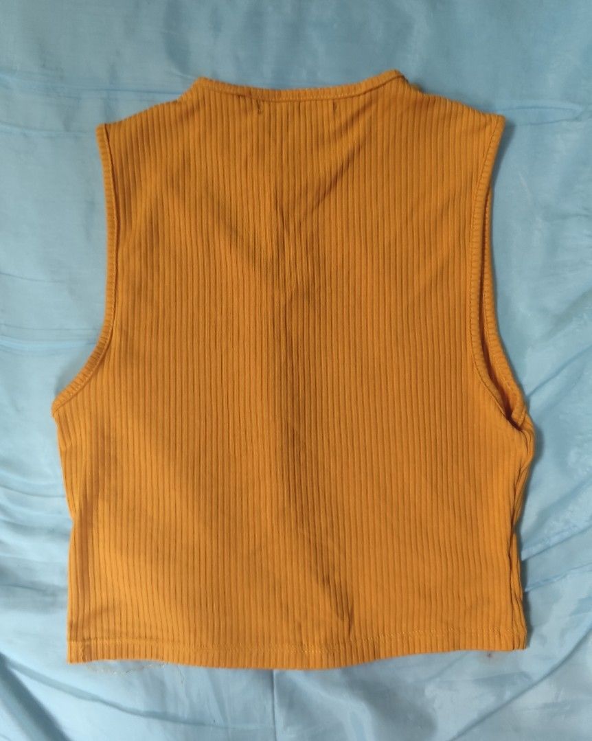 Mustard Yellow Ribbed Cut-Out Crop Top (Category: Sleeveless) located in Cavite. Submitted by emi_26 (Listing ID 1441659862, Image 2). Description: - Trendy yellow ribbed crop top - Sleeveless with a chic neckline cut-out - Stretchy and comfortable fabric - Perfect for pairing with high-waisted bottoms - Effortlessly transitions from casual to dressed-up looks.