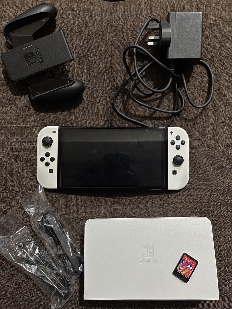 NINTENDO SWITCH OLED (Category: Nintendo) located in Quezon City. Submitted by jcvsd (Listing ID 1441714542, Image 1). Description: Nintendo Switch OLED 🎮✨ 🏷️ AVAILABLE comes with: ☻ nintendo switch OLED unit - ₱11,000 ☻ comes with: original dock, charger, joy-con straps, joy-con grip, and box ☻ free case and dock case ☻ free random thumb grip ☻ free soft pouch ☻ NBA 2K24 (cart only) • second hand — manage expectations • unli check upon meetup 
