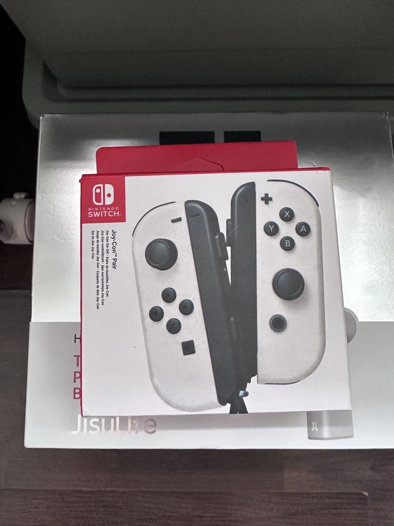 Nintendo Switch White Joy-Con Pair (Category: Controllers) located in Singapore. Submitted by im_eddie94 (Listing ID 1441672660, Image 1). Description: - White Nintendo Switch Joy-Cons (Left & Right) - Includes original packaging - Ideal for multiplayer gaming - Great as replacement controllers.