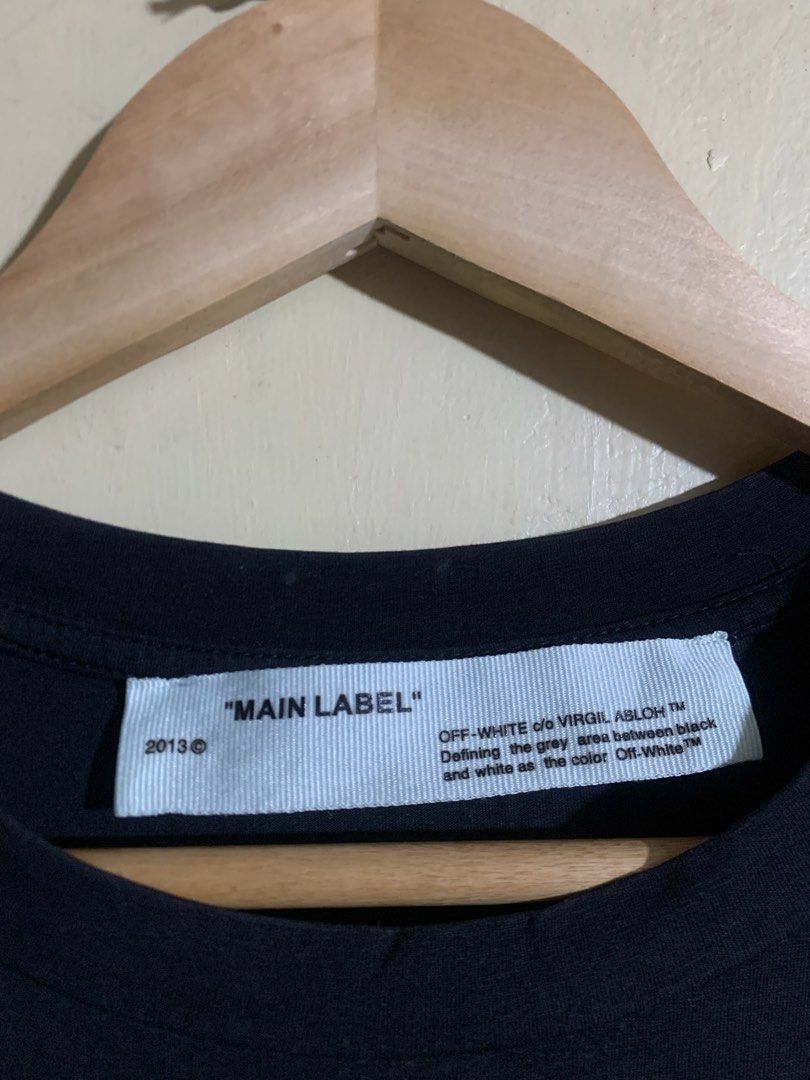 OFF-WHITE "MAIN LABEL" 2013 Black T-Shirt (Category: Tshirts & Polo Shirts ) located in Legazpi City. Submitted by casanibrah33153 (Listing ID 1441697354, Image 3). Description: - Authentic 2013 Black OFF-WHITE T-Shirt - Front: 'MAIN LABEL' graphic with red '6' and sparkling details - Back: Iconic OFF-WHITE arrow logo embellished with rhinestones - Made in Portugal - Perfect addition to any streetwear collection.