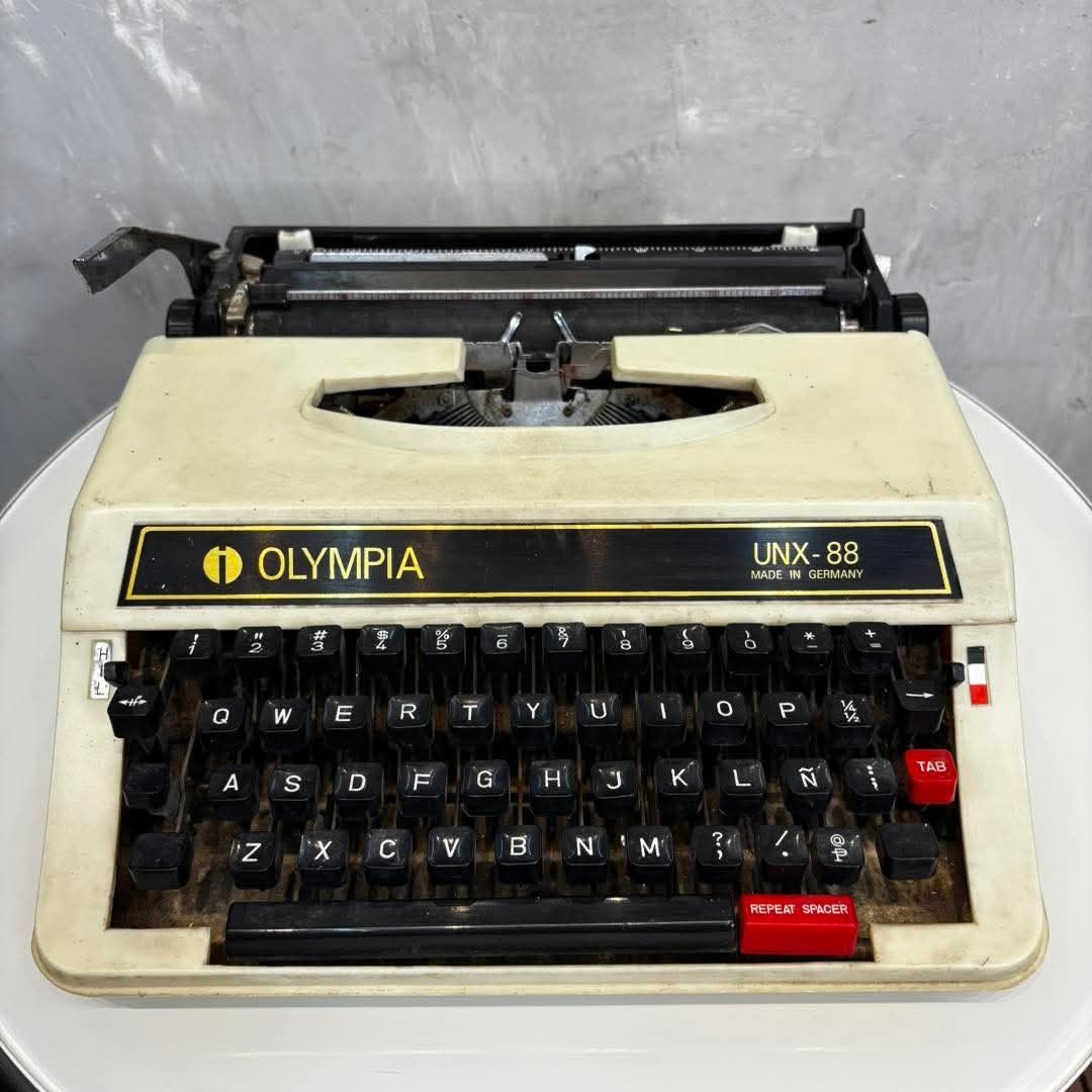Olympia UNX-88 Typewriter Made in Germany (Category: Office & Business Technology) located in Valenzuela. Submitted by upcycle_things (Listing ID 1441590796, Image 1). Description: - Olympia UNX-88 mechanical typewriter - Made in Germany - Black keys with white lettering - Red TAB and REPEAT SPACER keys - Shows some signs of wear and dust - Ideal for collectors or display.