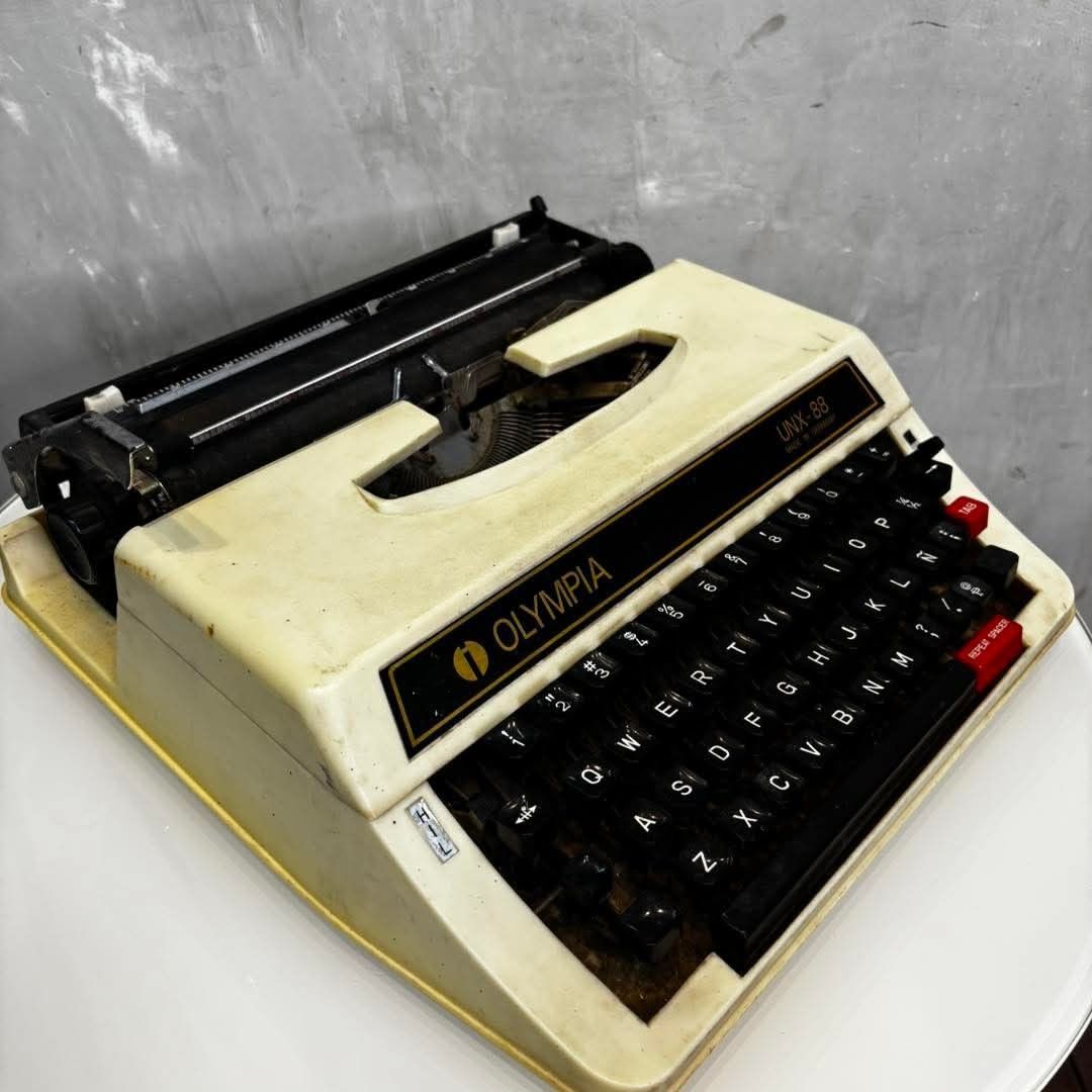 Olympia UNX-88 Typewriter Made in Germany (Category: Office & Business Technology) located in Valenzuela. Submitted by upcycle_things (Listing ID 1441590796, Image 2). Description: - Olympia UNX-88 mechanical typewriter - Made in Germany - Black keys with white lettering - Red TAB and REPEAT SPACER keys - Shows some signs of wear and dust - Ideal for collectors or display.